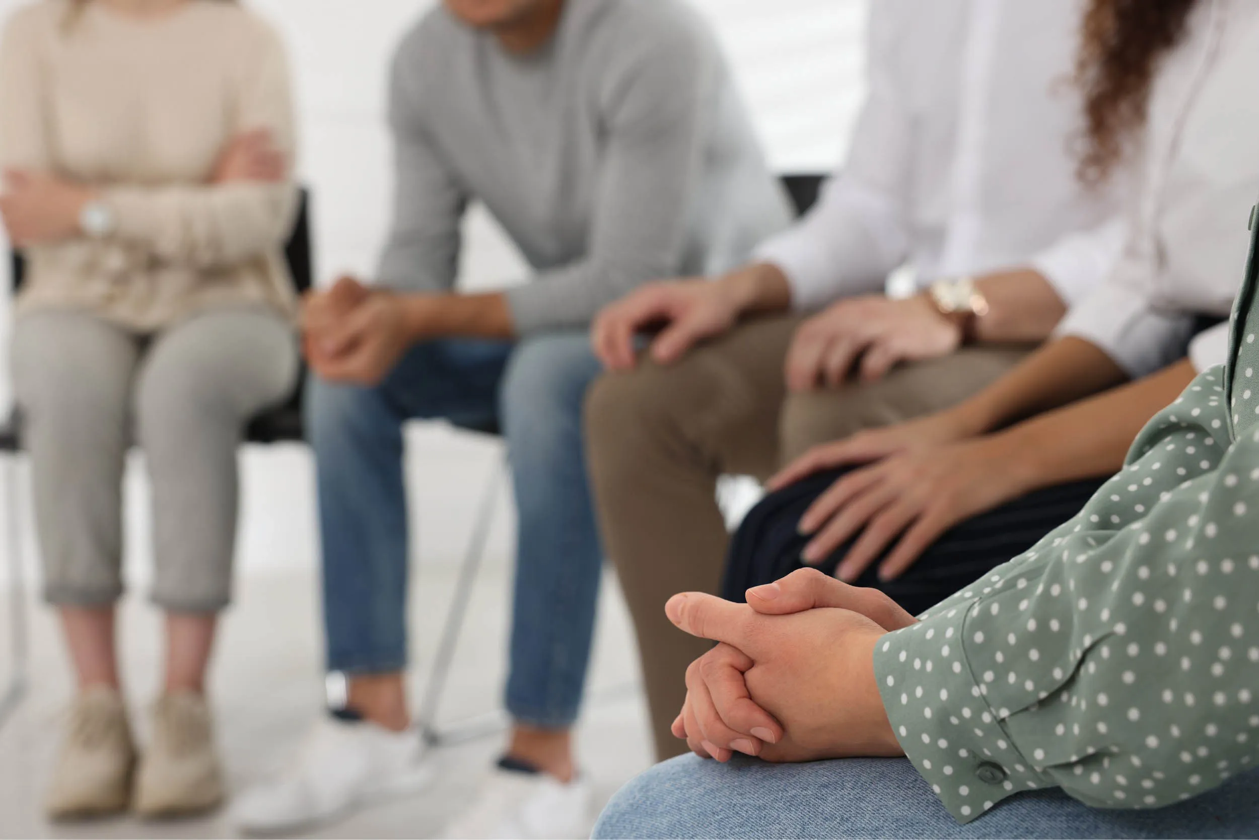 A peer support circle seated in conversation