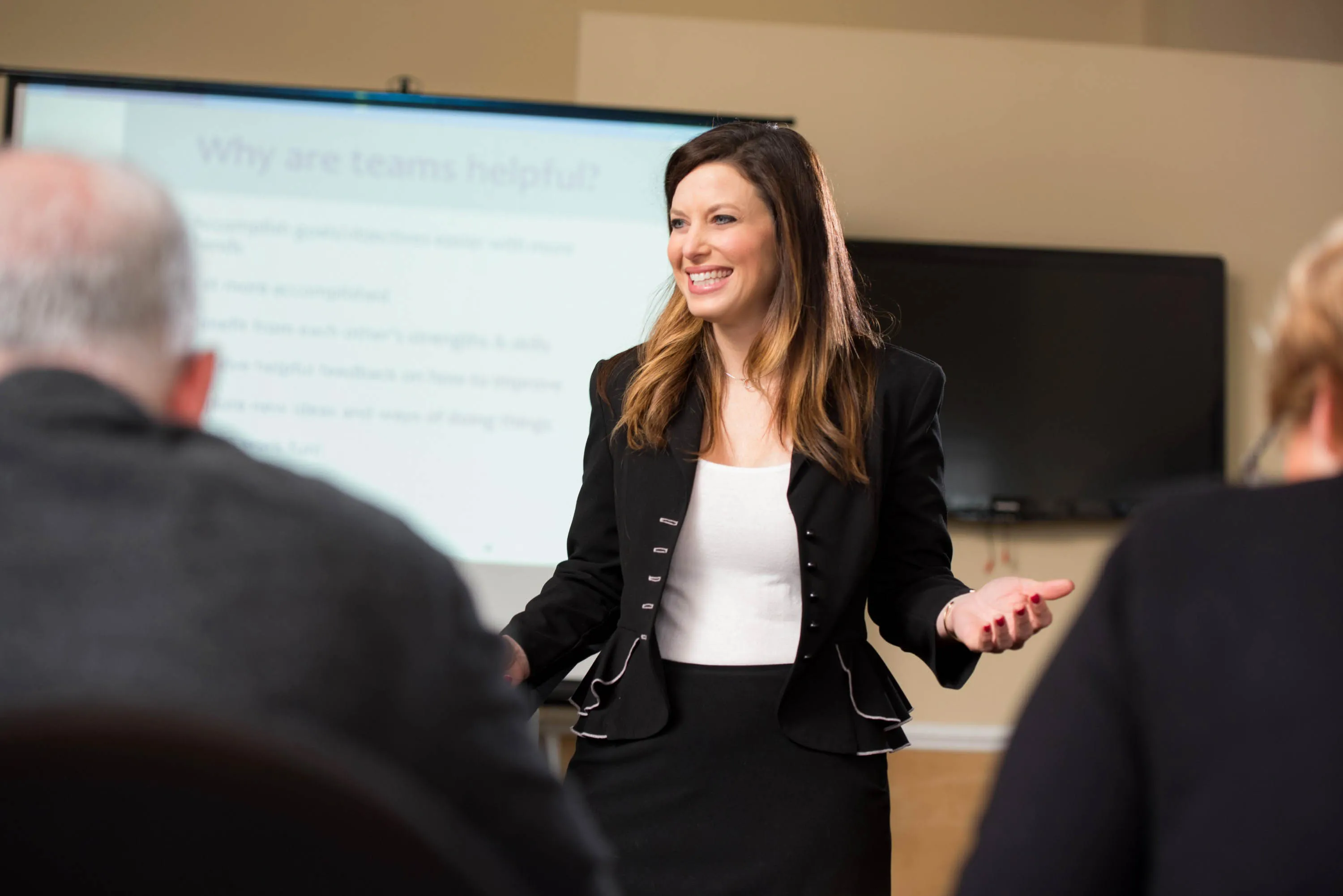 A trainer presenting to a room of professionals